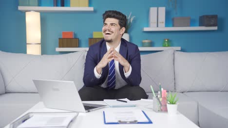 home office worker who is satisfied with his work laughs with happiness.