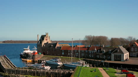 Aerial:-The-historical-town-of-Veere-with-an-old-harbour-and-churches,-on-a-spring-day