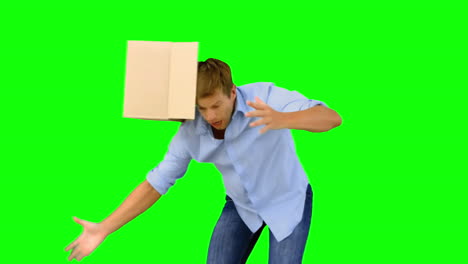 clumsy man dropping boxes down on green screen