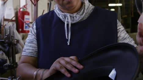 mixed race woman working at a hat factory