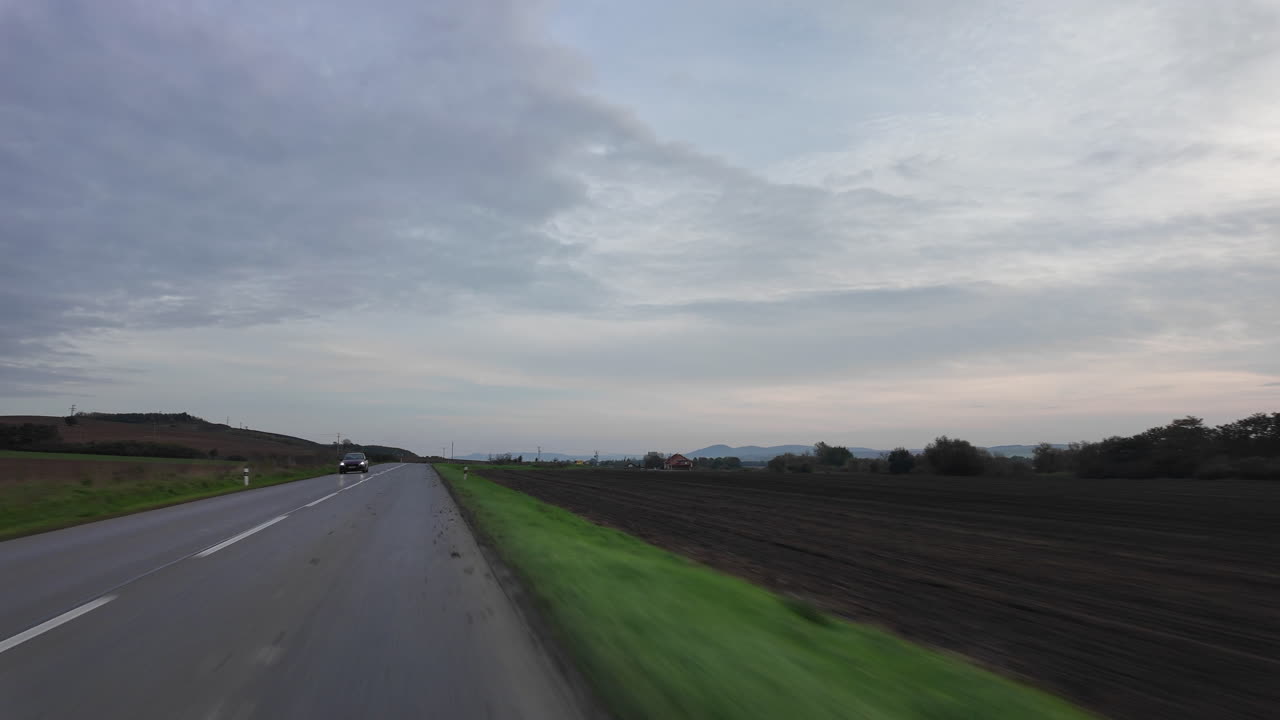 Driving through the countryside on a cloudy day