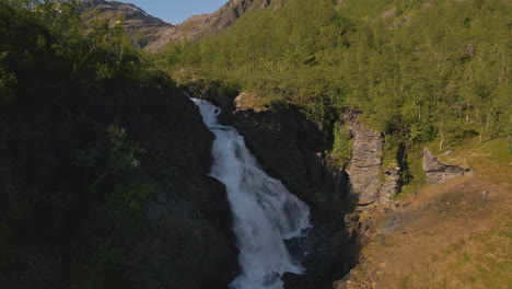 turelva rapids rushing from steep rocky mountains in finnmark, norway