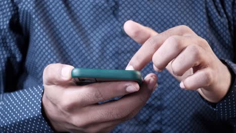 close-up of a man using a smartphone