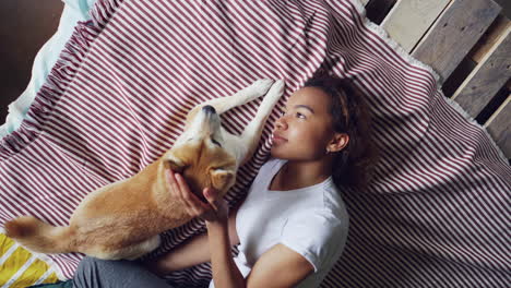 woman and her dog sleeping on a pallet