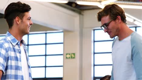 Male-executives-shaking-hands-in-office