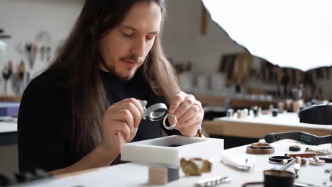 jeweler inspecting a ring under magnifying glass
