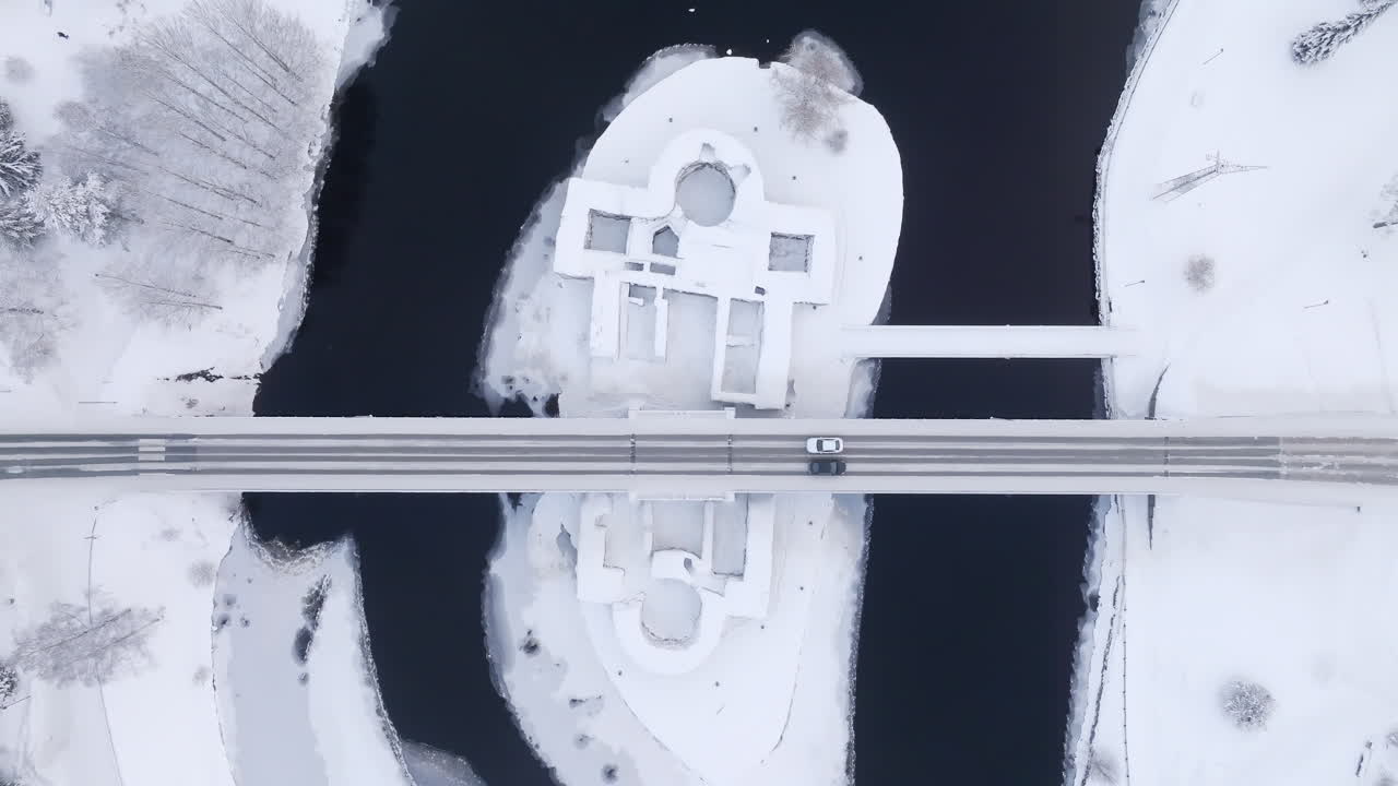 Overhead aerial view above the Kajaani castle and traffic, winter day in Finland