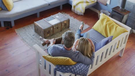 Happy-caucasian-mature-couple-having-fun-and-sitting-in-in-living-room