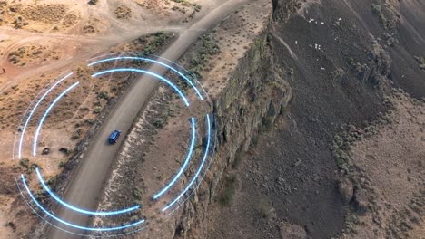 drone shot of a self driving blue suv sensing its way through a unique cliffside environment