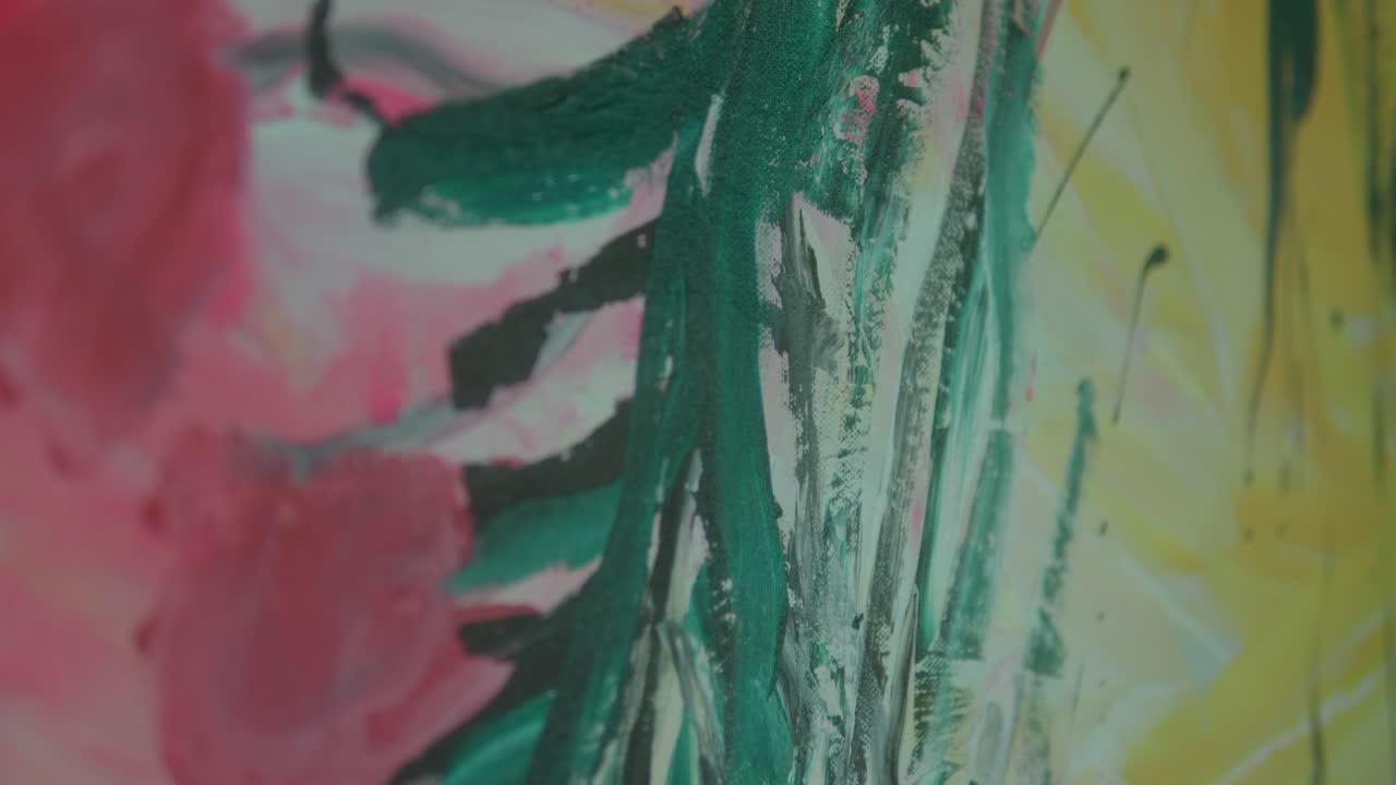 Close-up view of vibrant abstract brushstrokes with a mix of pink, green, and yellow hues creating a dynamic texture