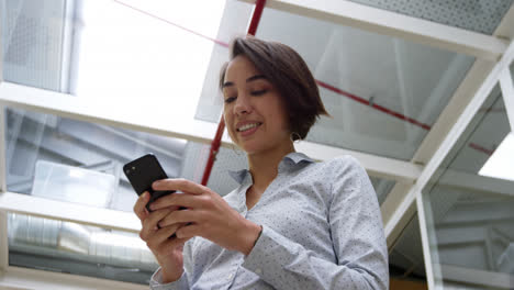 Businesswoman-using-mobile-phone-in-modern-office-4k