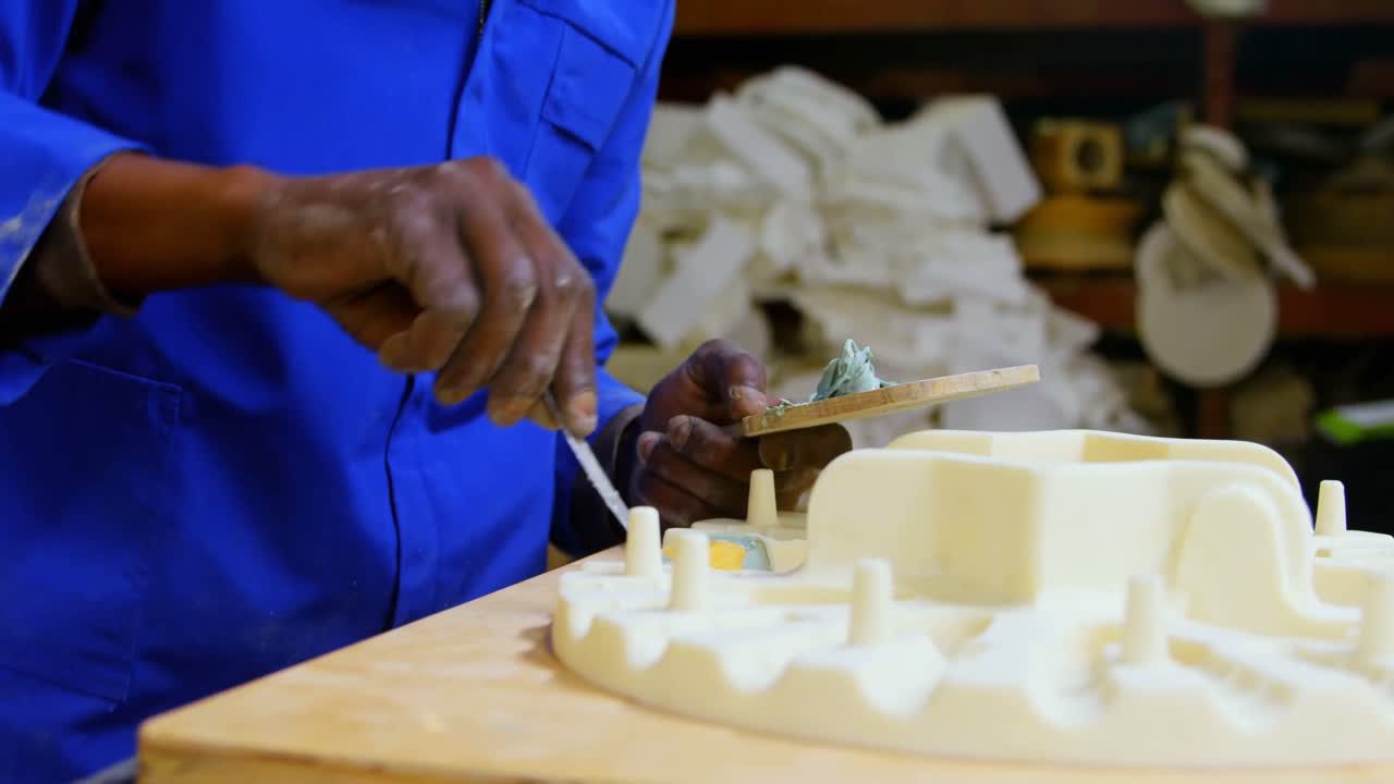 Mid section of worker working on molds in foundry workshop 4k