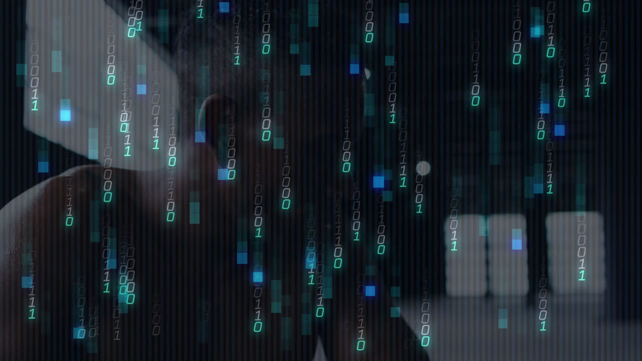 Binary code animation over person working on computer in dark room