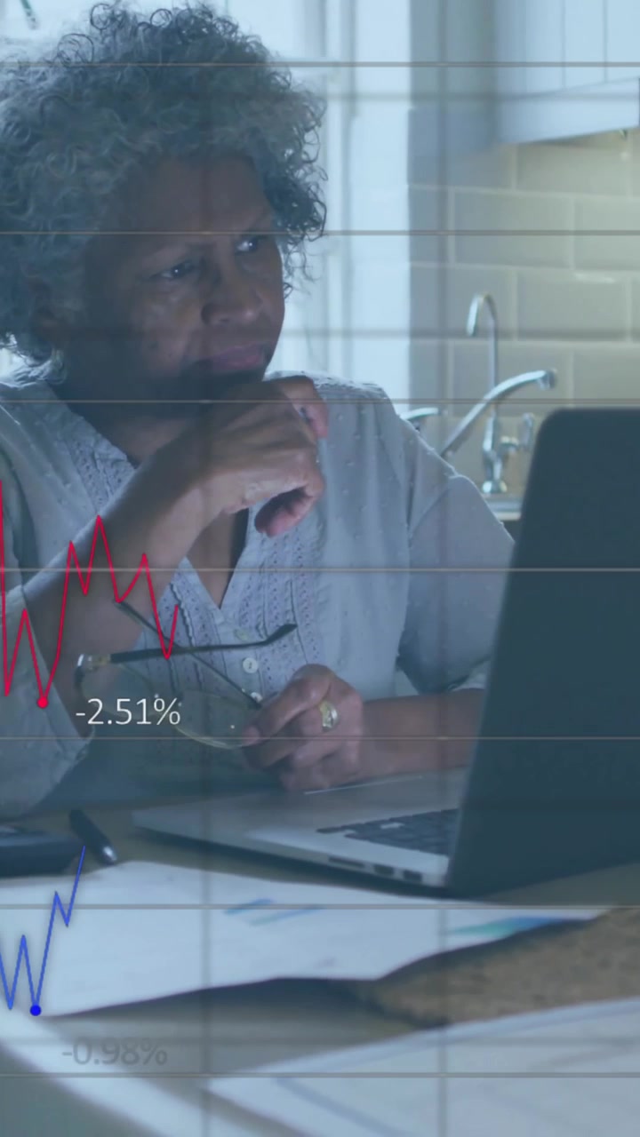 Animation of financial data processing over senior african american woman using laptop