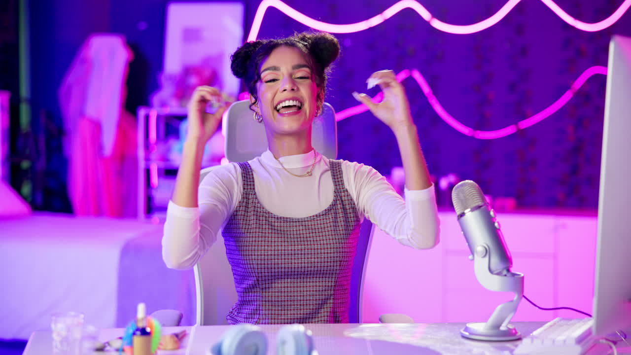 Excited woman celebrating at her desk with a microphone