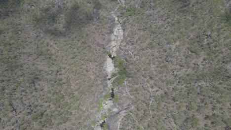 Bird's-Eye-View-Over-Emerald-Creek-Falls-And-Surroundings-In-Mareeba,-Australia---drone-shot