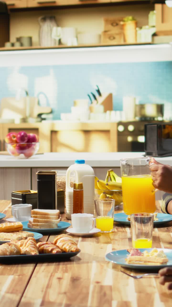 Vertical Video Parents and children starting the day with healthy breakfast of pastry and eggs