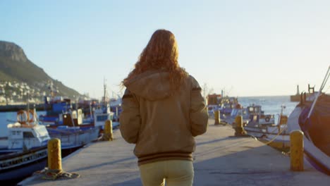 woman walking on the dock 4k