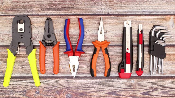 Pliers moving on the wooden table with construction and work tools - Stop motion