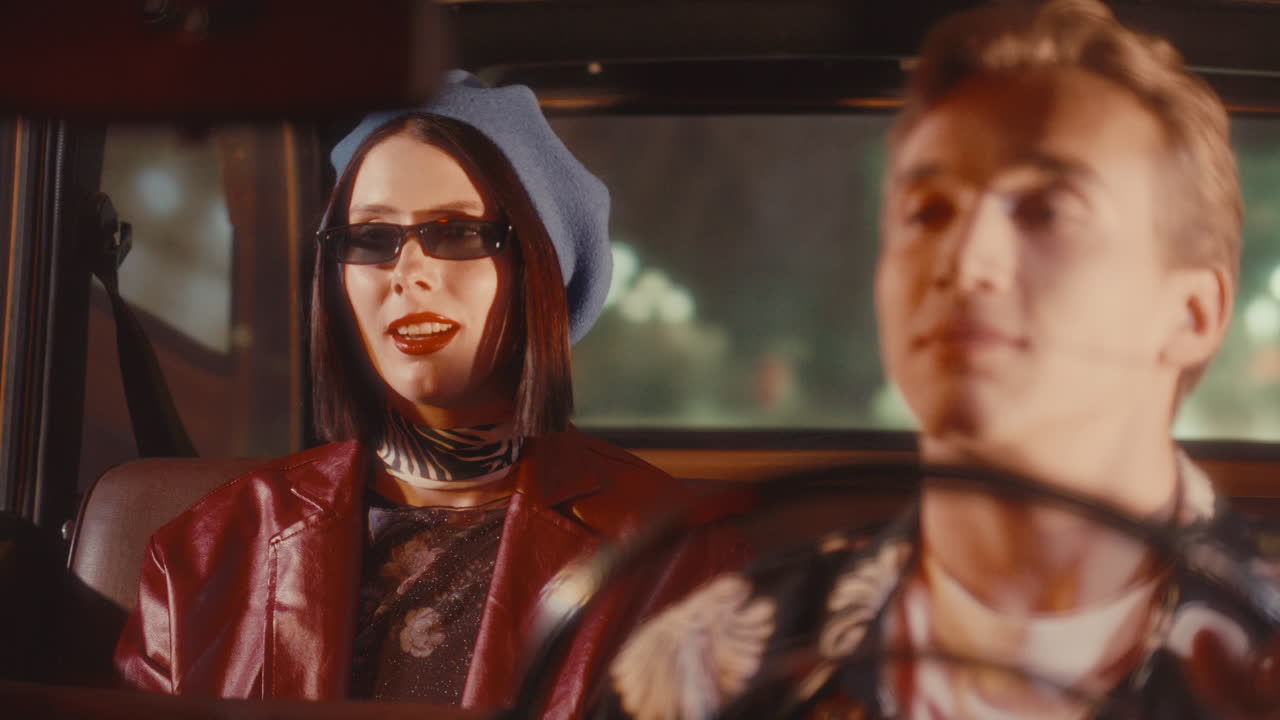Stylish Woman Smiling in Back Seat of Vintage Car and Talking to Driver