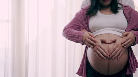 pregnant couple feels love and relax at home.