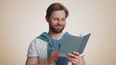 man making notes, writing down thoughts with pen into notepad notebook diary, to do list, good idea