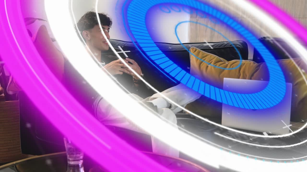 Man relaxing on sofa, scrolling smartphone while neon rings sweeping, partly revealing man and tech
