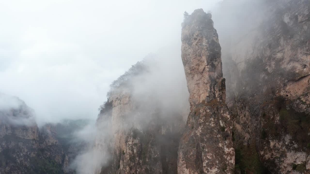 Aerial Shot of Mist-Covered Rugged Cliff Formation