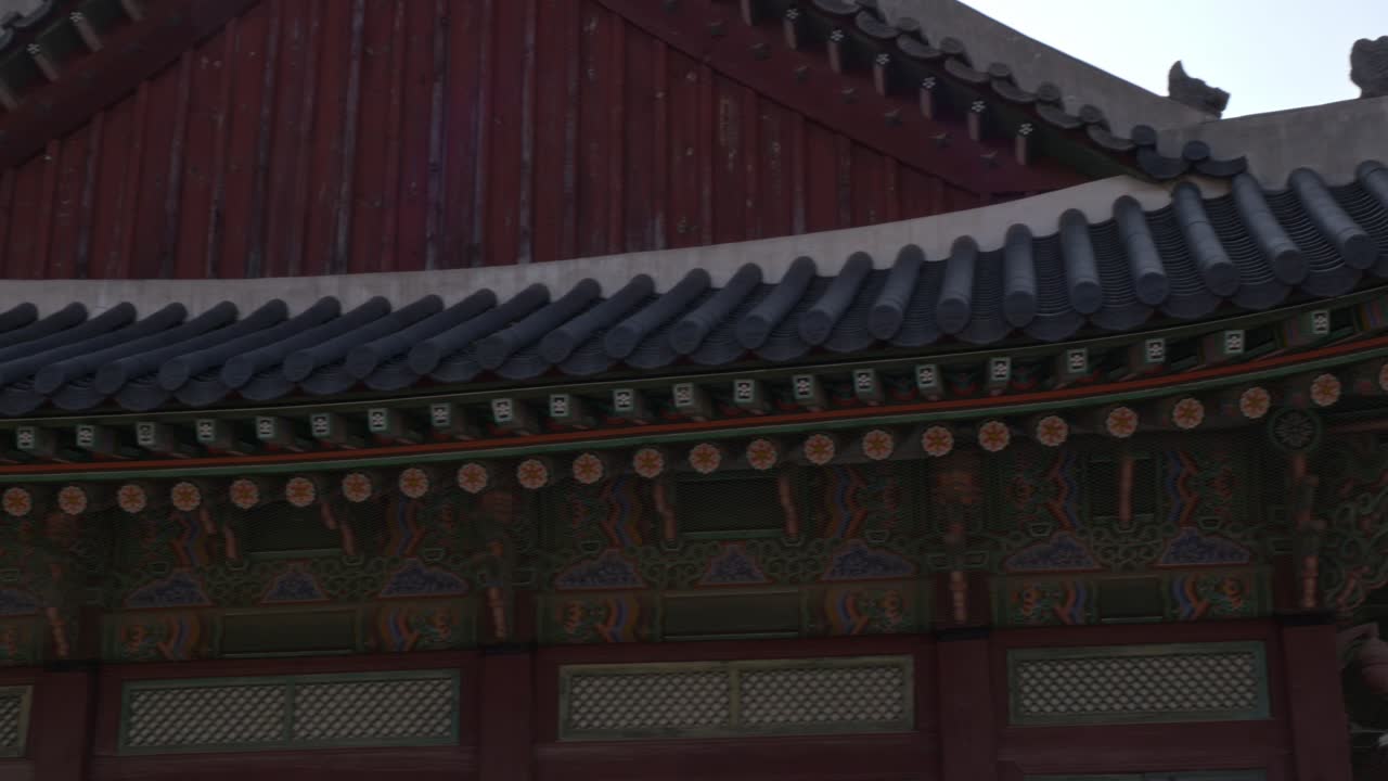 Traditional Korean Palace Roof With Ornate Dancheong Patterns And Curved Eaves. closeup, panning shot