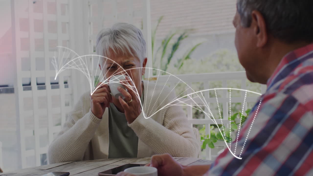 Senior couple sipping coffee on veranda, featuring smartphone tablet graphics for technology design