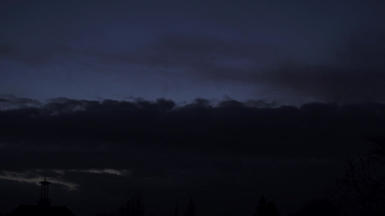 cumulonimbus cloud moving at sunset sky time lapse silhouette clock tower
