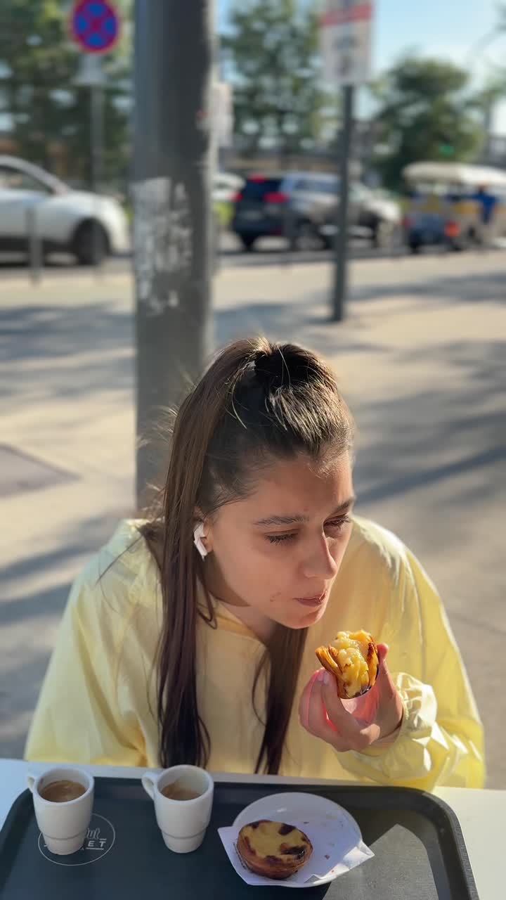 Woman enjoying a Pastéis de Nata