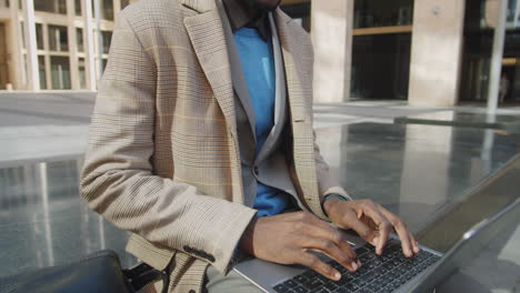 Young-African-American-Businessman-Working-on-Laptop-Outdoors