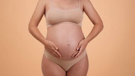 pregnant woman touching her belly