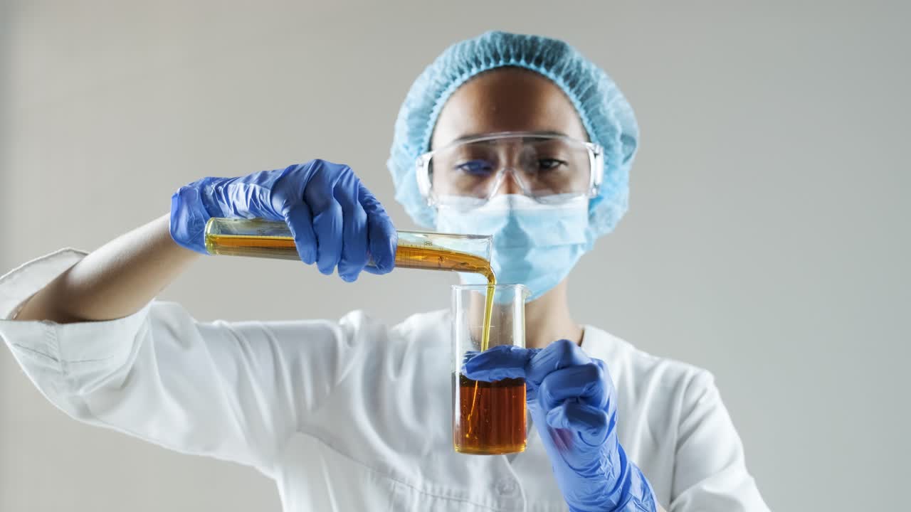Scientist pouring liquid in a laboratory setting