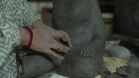 Hands-sculpting-a-detailed-clay-figure-with-care-and-precision