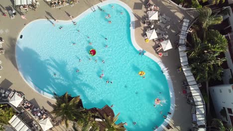 drone-rotate-above-swimming-pool-in-luxury-resort-with-palm-tree-tropical-sunny-destination