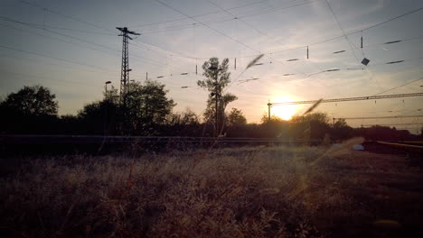 trainstation at sunset with train - low angle