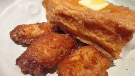 cinematic profile view of golden toasted french toast wings kept on a white colored dish