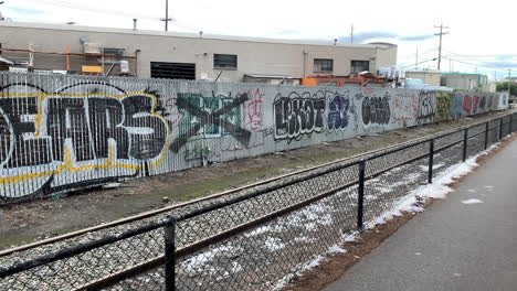 graffiti on a fence passes by in an industrial area of seattle