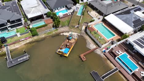 drone captures barge and crane in urban canal