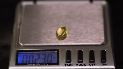 weighing a gold gemstone