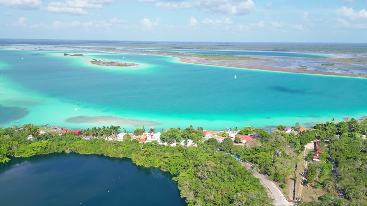 Clear turquoise waters of Bacalar, Mexico with lush green landscapes and islands