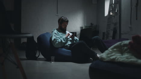 man working on laptop in a basement home office