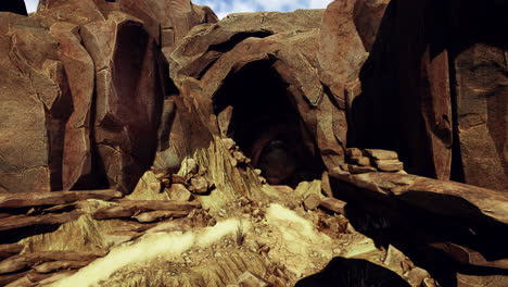 a cave entrance in a rocky desert landscape