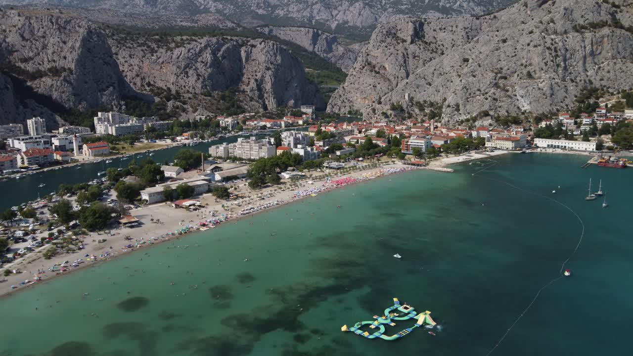 Aerial establishing view of scenic croatian mountains and coastal town omis hrvatska