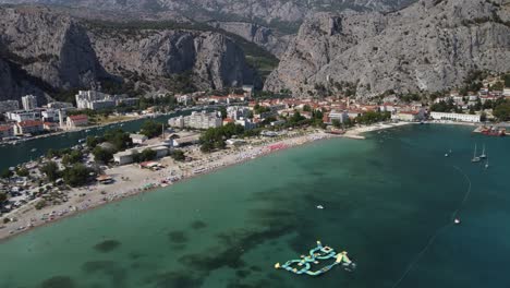 aerial establishing view of scenic croatian mountains and coastal town omis hrvatska