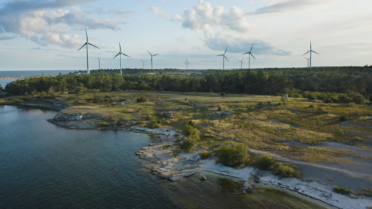 Aerial shot of a coastline with wind power plants