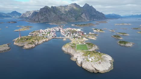 henningsvaer soccer field and village in lofoten island archipelago, norway - 4k aerial circling