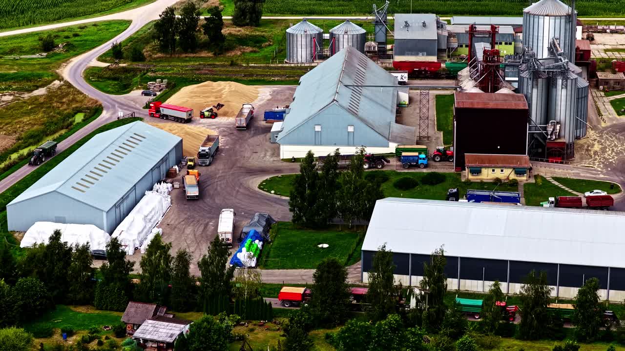 Aerial View of a Farm with Grain Elevators and Trucks